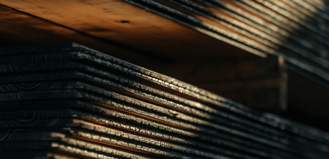 Stacked Yakisugi a.k.a Shou Sugi Ban charred Japanese cedar boards showing the textured carbonised surface.