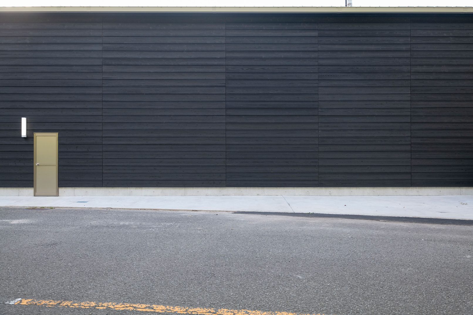 Minimalist building facade with Yakisugi a.k.a Shousugiban cedar cladding.