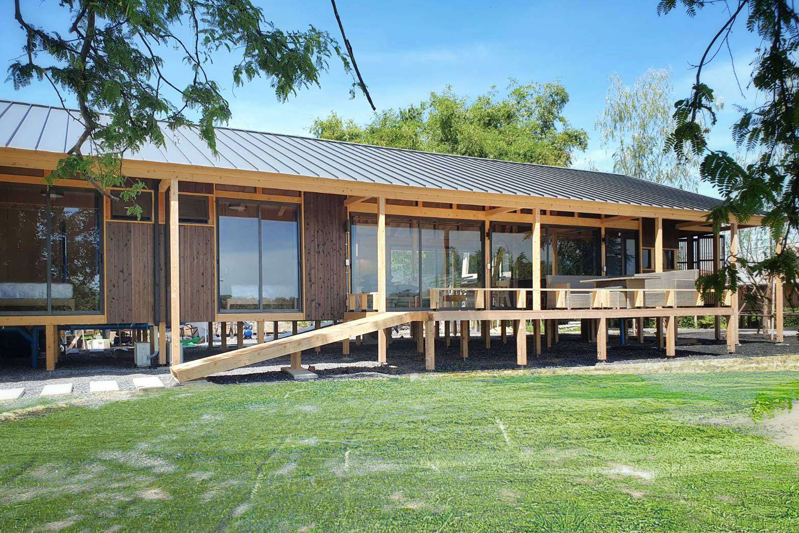 Modern house with Yakisugi a.k.a Shousugiban cedar cladding and raised timber deck.