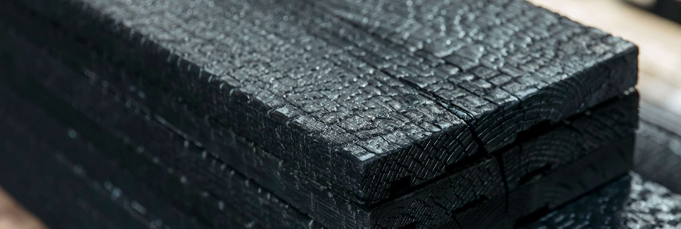 Yakisugi Charred Cedar Timber Boards Close up of Yakisugi a.k.a Shou Sugi Ban charred Japanese cedar timber boards showing the carbonised surface texture.