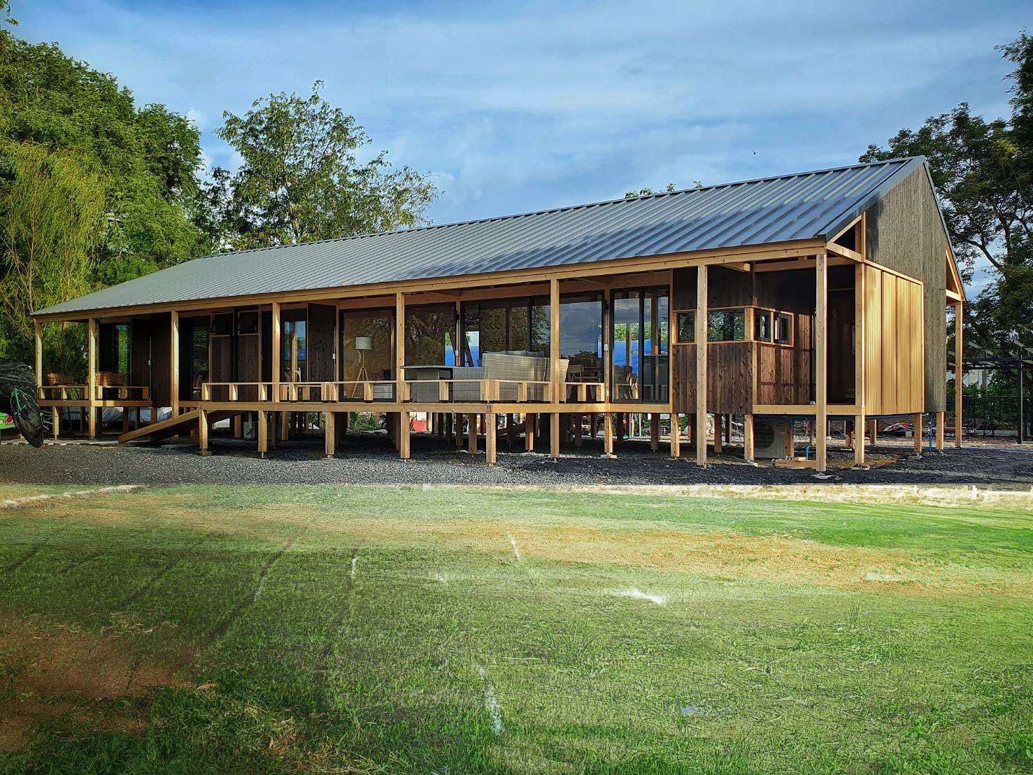 Modern house with Yakisugi a.k.a Shousugiban cedar cladding and raised timber deck.