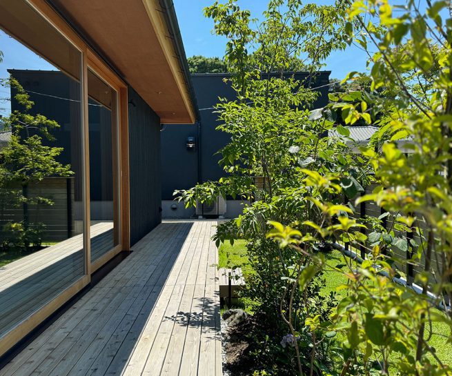 Modern house with Yakisugi a.k.a Shousugiban cedar cladding and garden deck.