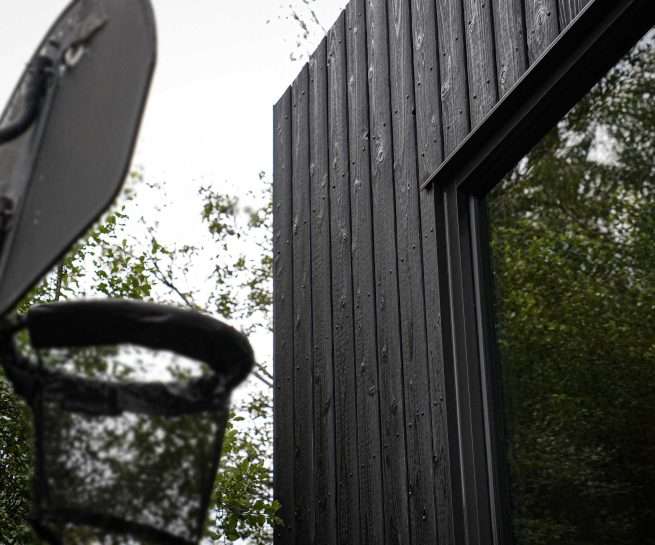 Hakuu Black yakisugi cladding beside a window on the Glen Iris House facade, Melbourne